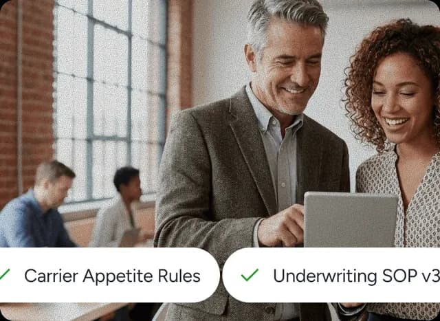 Two colleagues reviewing an answer cited to carrier appetite rules and an underwriting SOP